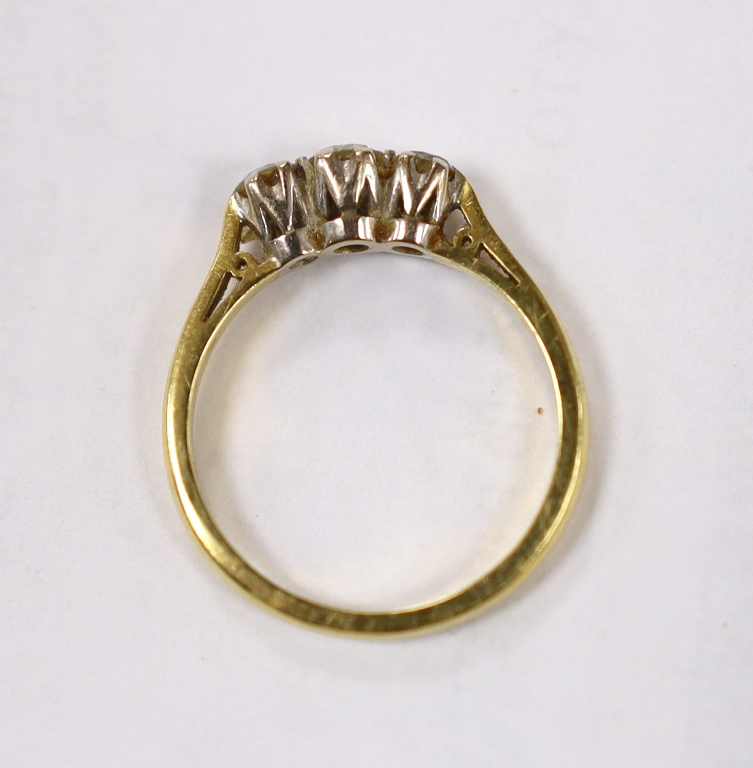 A modern 18ct white gold and three stone diamond set ring, size P, gross weight 3.9 grams.